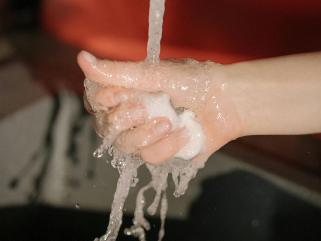 Washing with foamy soap – highlights proper water drainage and cleanliness.