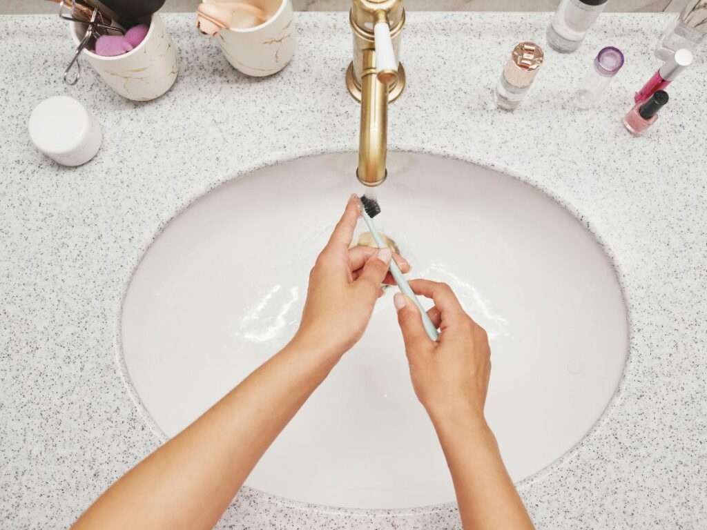 Washing hands in a bathroom sink – emphasizes clean water safety.