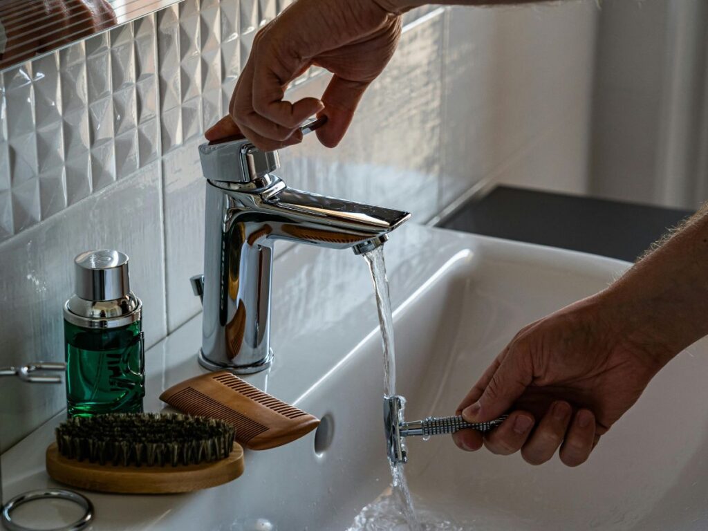 Turning faucet knob – essential part of plumbing backflow setups.
